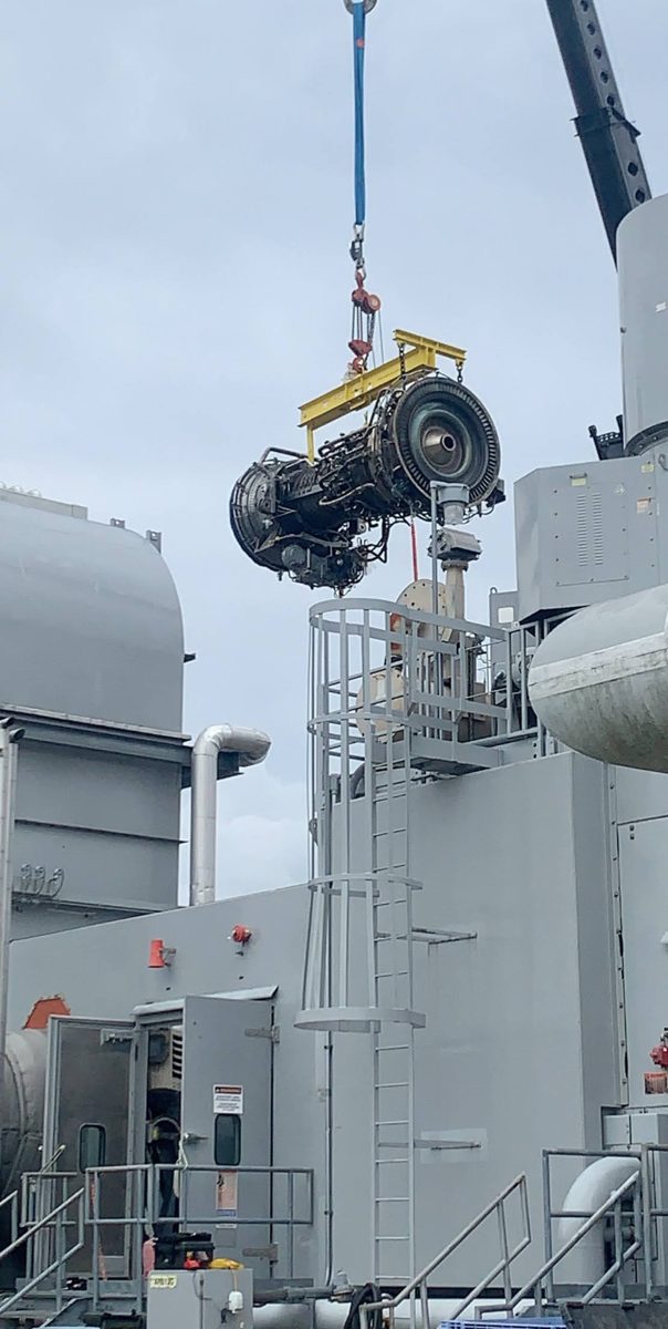Heavy turbine equipment being lifted by crane